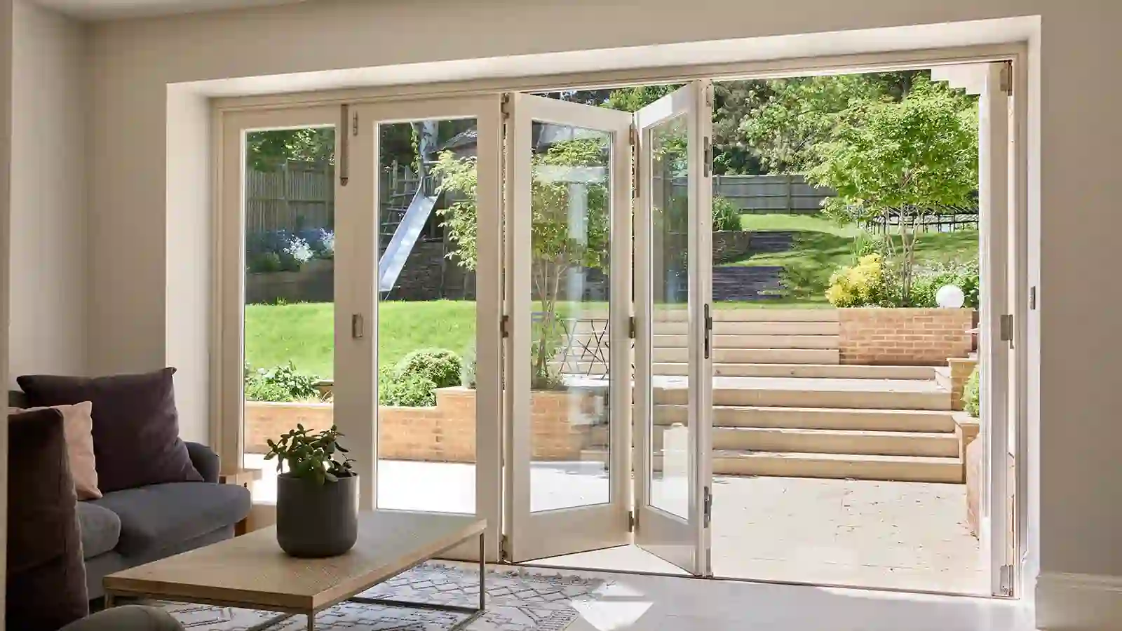 Bi-folding doors opened fully onto a garden patio