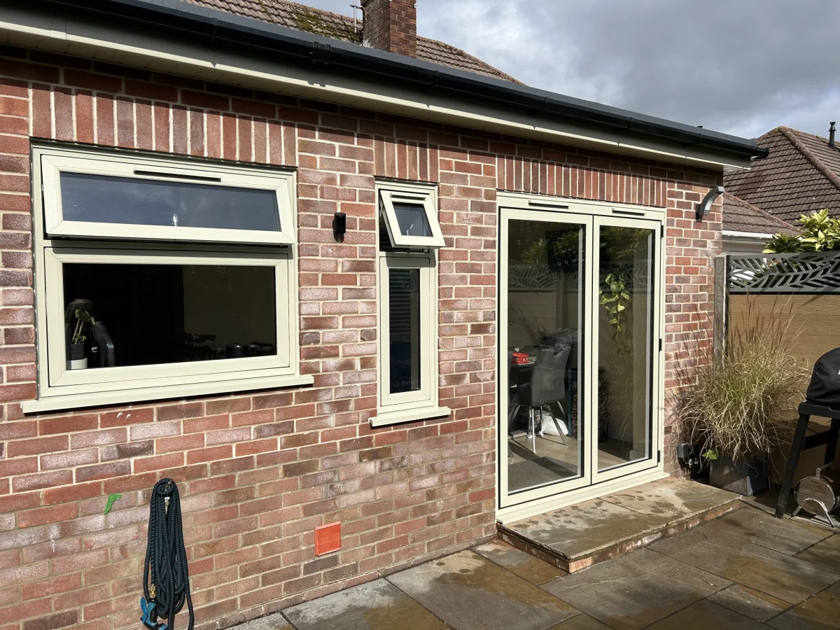 Cream uPVC French doors with casement window above