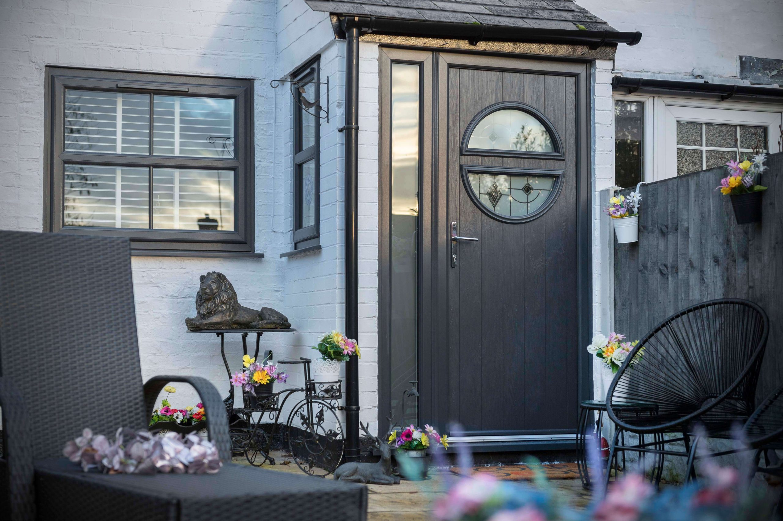 Dark anthracite composite front door with a decorative glazed panel, fitted to a Southampton cottage