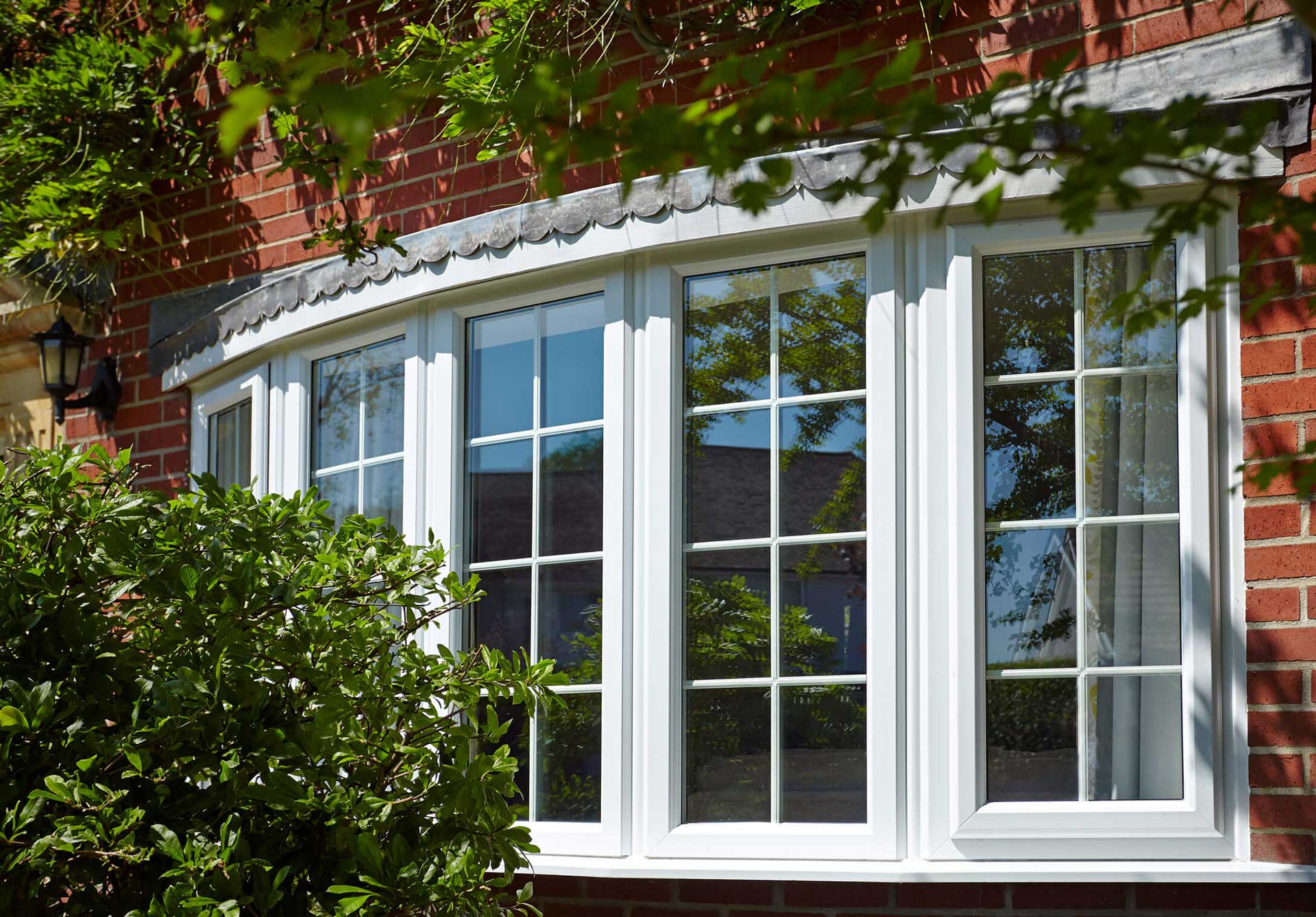 White uPVC bay and bow window fitted to a red-brick Southampton home