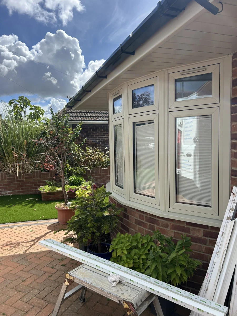 Cream uPVC casement windows, top-hung, on a garden building