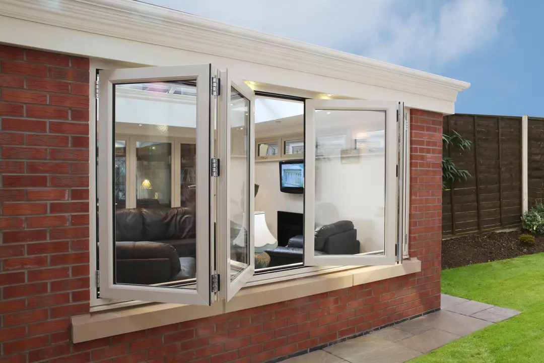 Bi-folding windows fully open onto a conservatory