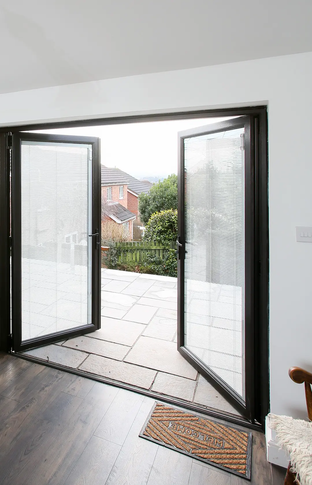 Aluminium bi-fold doors open onto a patio